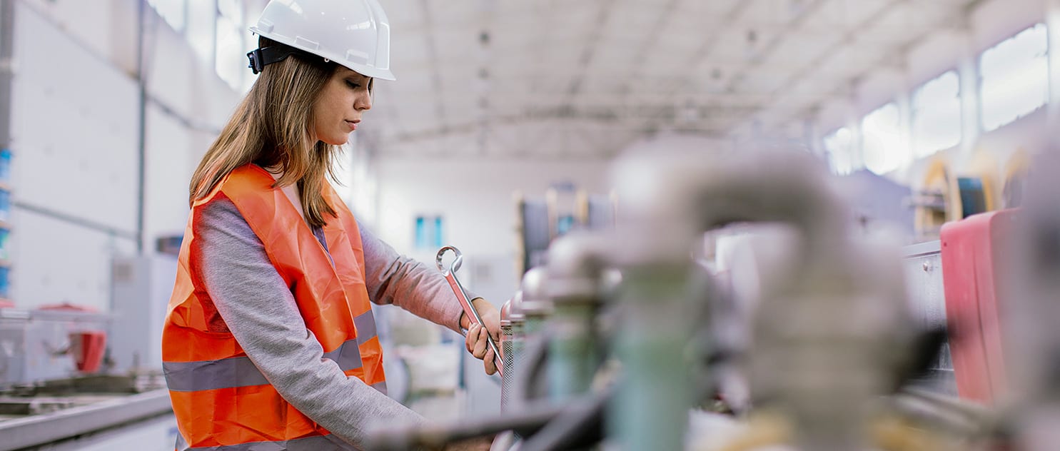 Woman employing safe work practices in a factory